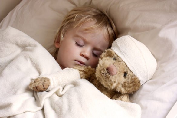 Boy and teddybear in bed, with teddy bandaged