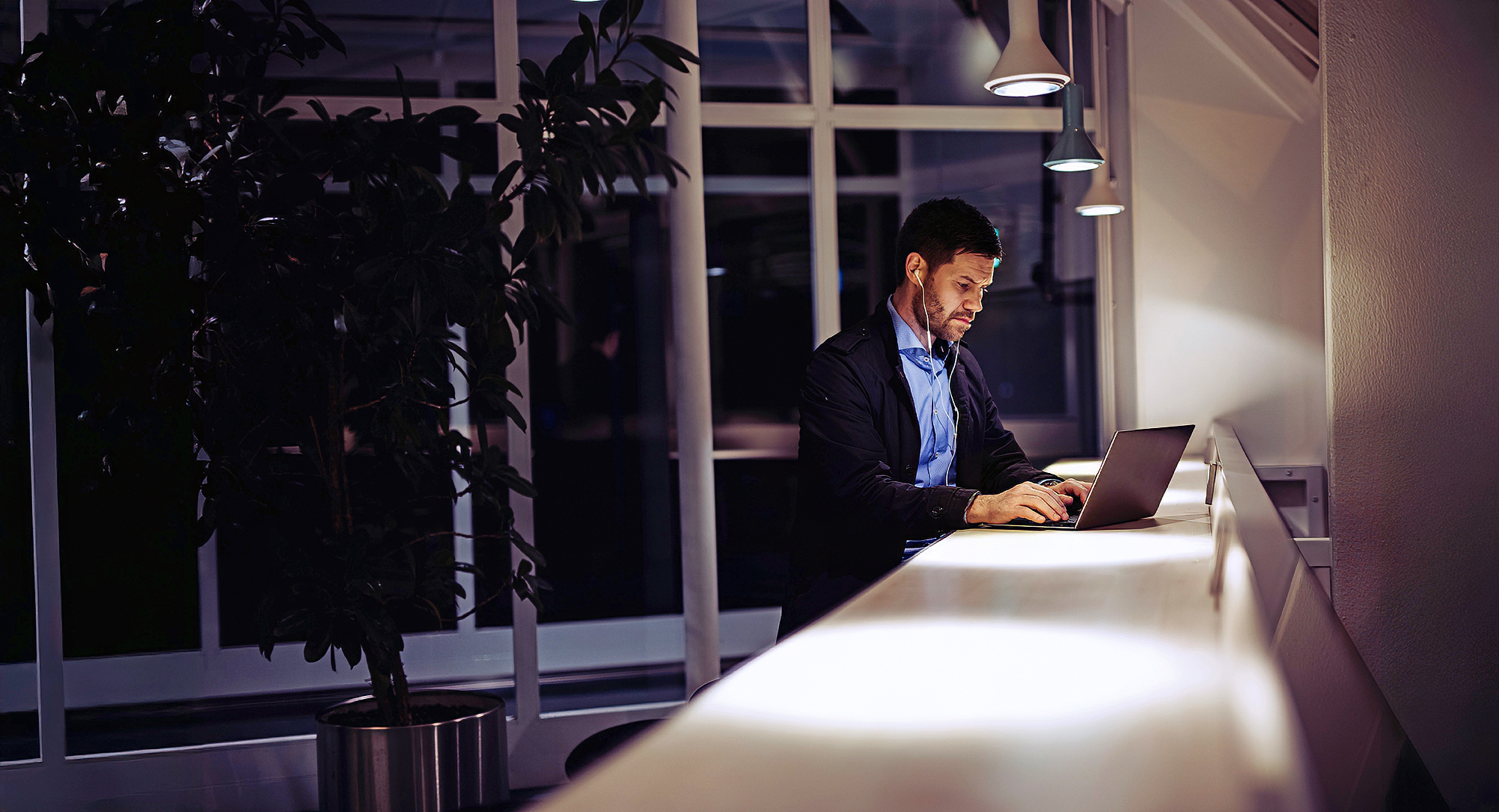 Man with laptop in a lobby