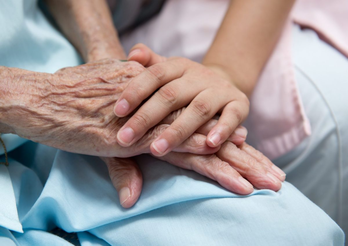 Patient and relative hold hands