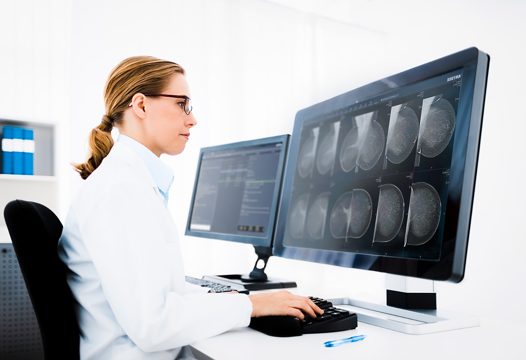 Female radiologist reading breast images on Sectra Breast Imaging PACS (new GUI)