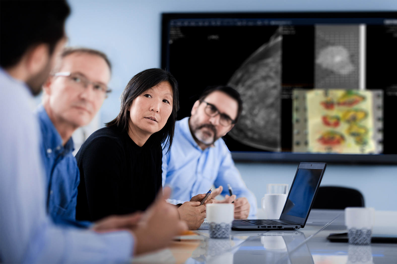 Team of doctors at a multidisciplinary team meeting, discussing a patient case