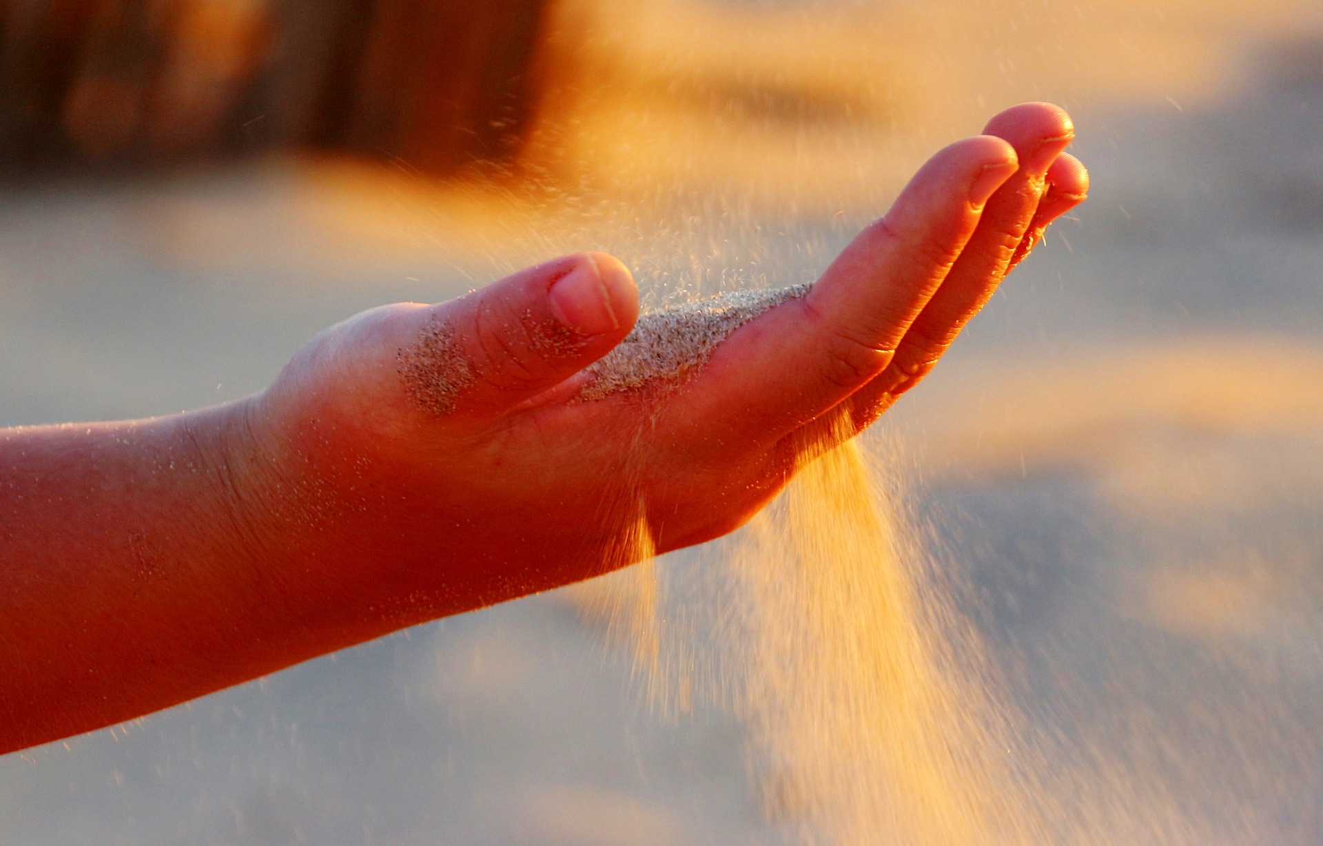 Sand running through an open hand