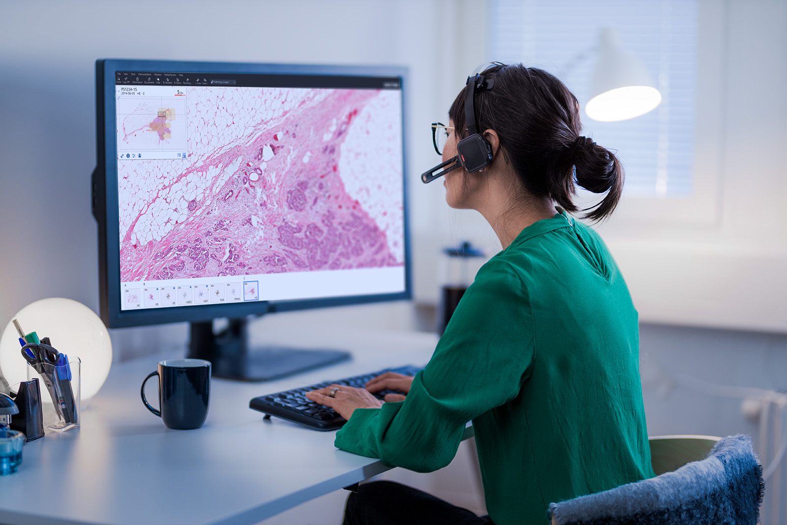 Female pathologist in front of a monitor