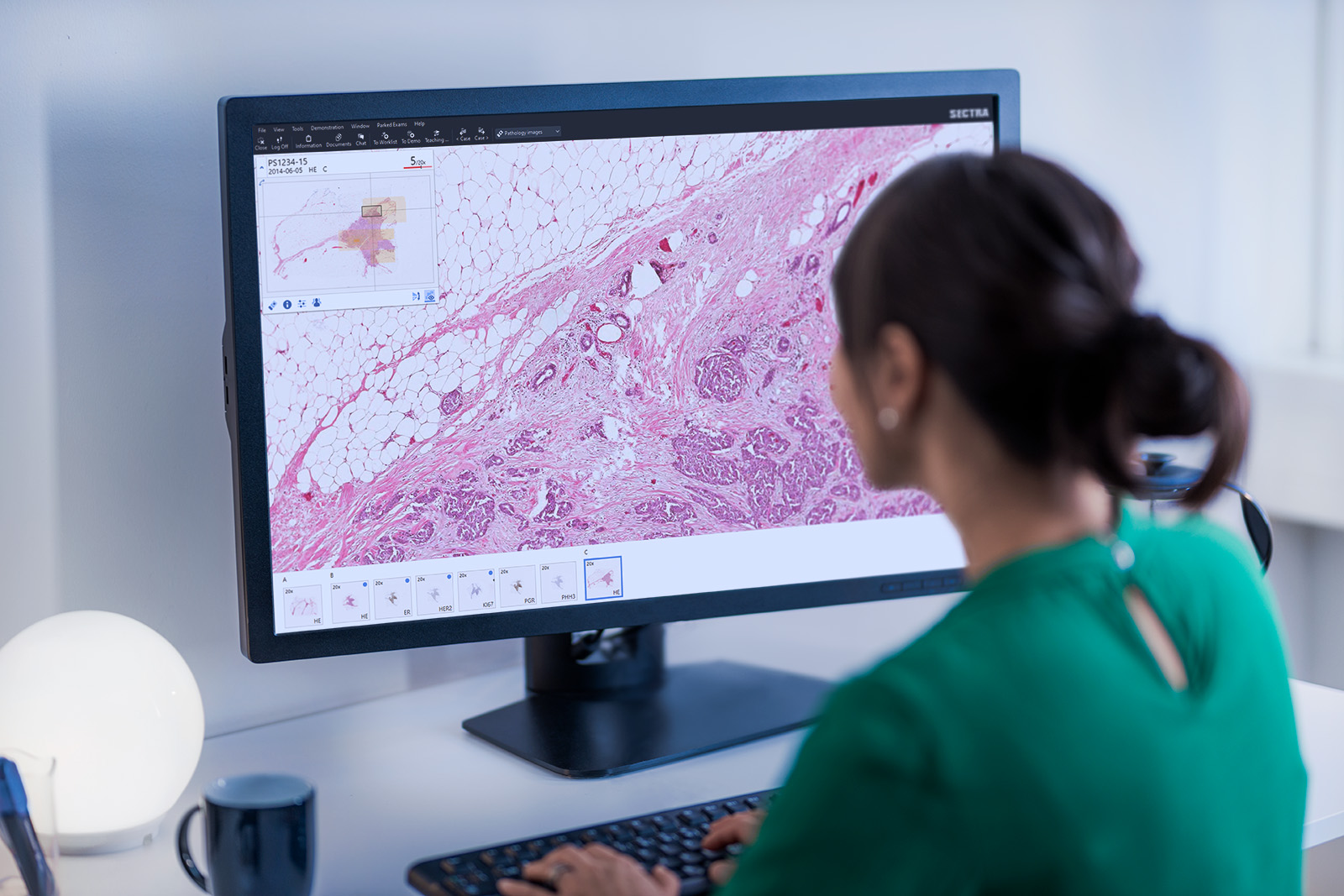 Female pathologist in front of a monitor